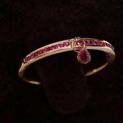 Gold Half Ruby Eternity Thumb Ring with a dangling Pink Tourmaline
18ct gold with 0.23ct of Ruby
